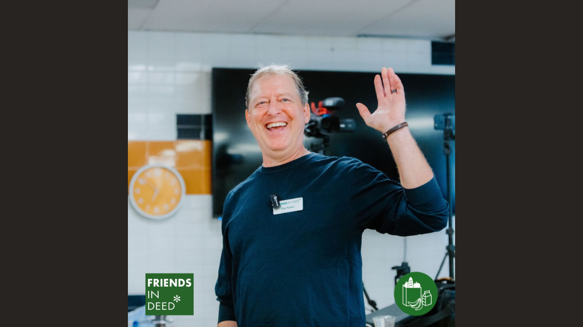 A white middle age man waves with a broad grin on his face. A green logo in the lower left hand corner says Friends In Deed