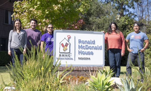 Staff members at Pasadena's Ronald McDonald House pose outside with their welcome sign.