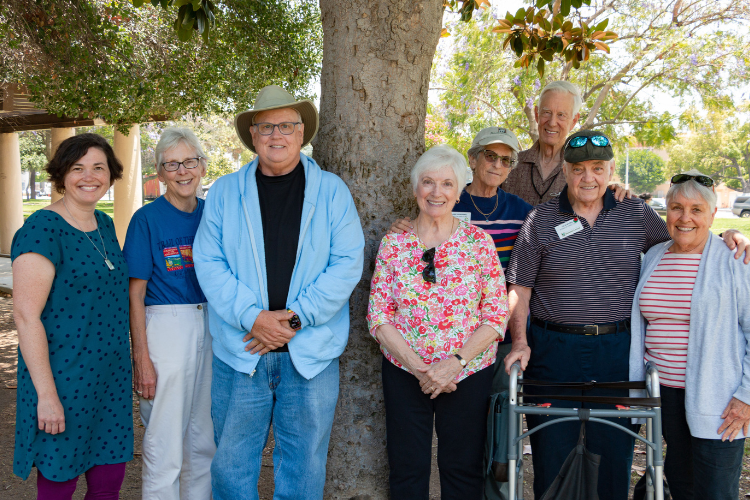 Members of Pasadena Village pose together under a tree.