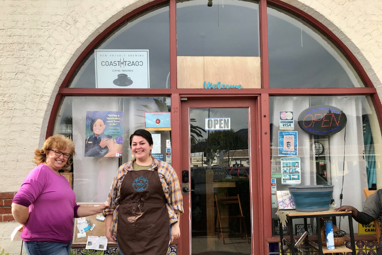 Two women pose in to the left of the front door of My Place Cafe in Pasadena CA 