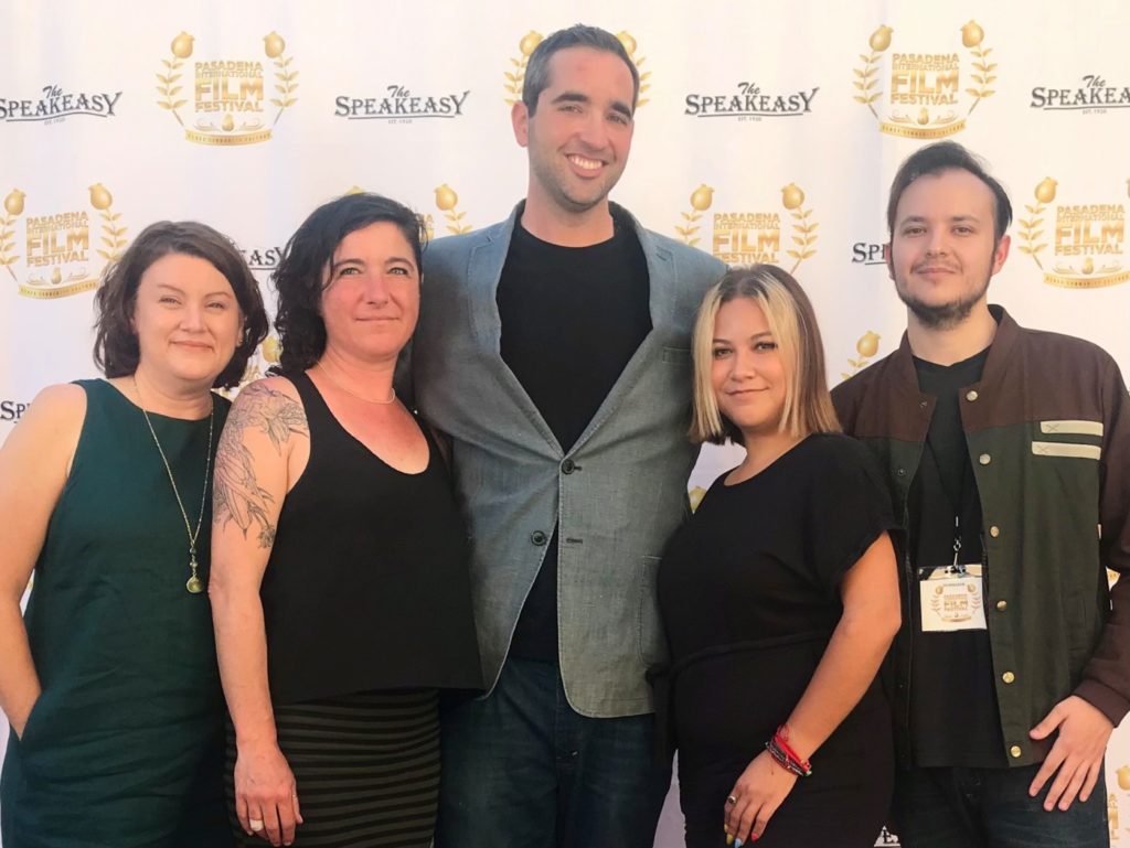 five adults on a red carpet at the Pasadena International Film Festival