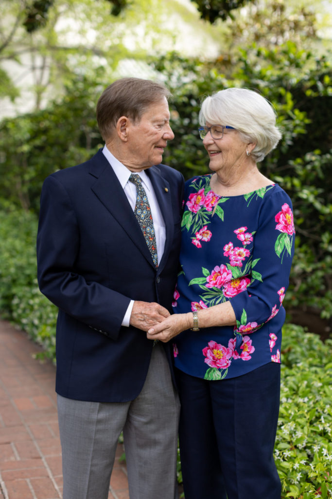 Elderly couple embracing in a garden