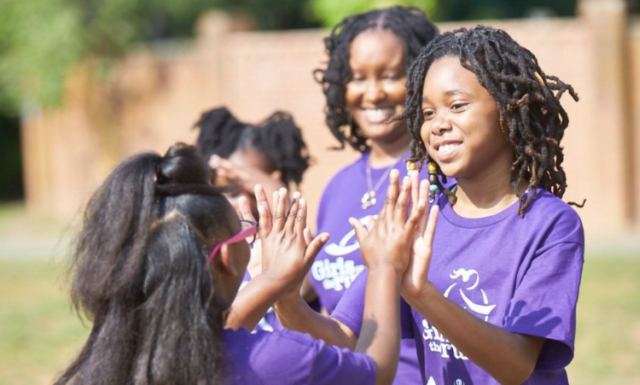Several girls from Girls on the Run organization play together.