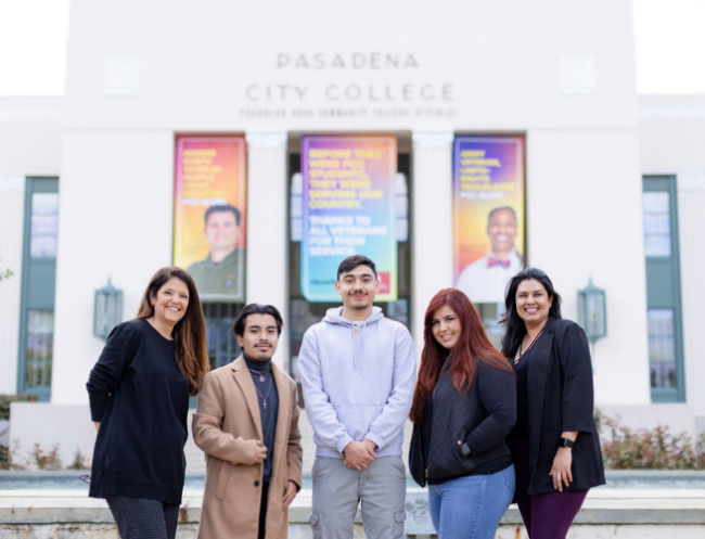 Five individuals stand together outside of Pasadena City College posing for a photo.