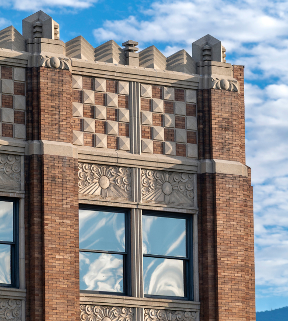 Detail shot of an Art Deco-style building showing detailed friezes and brickwork
