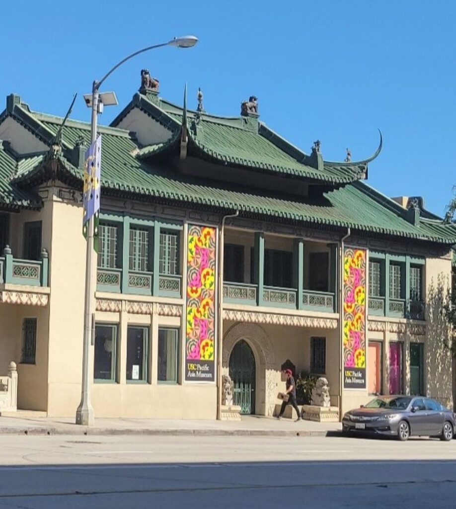 Asian archetectural building with mural of variety of sea birds on side of the building