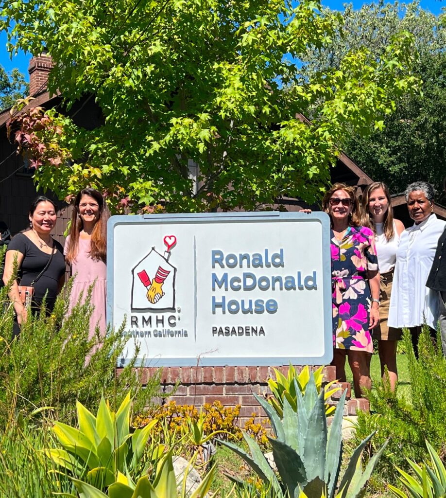 Group of women taking a photo next to the Ronald McDonald House in Pasadena