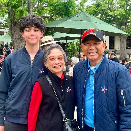 Family of three smiling for a photo