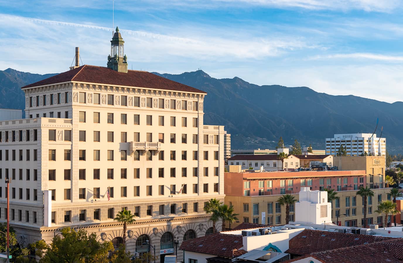 Image of building on with ton of windows with California mountians behind it