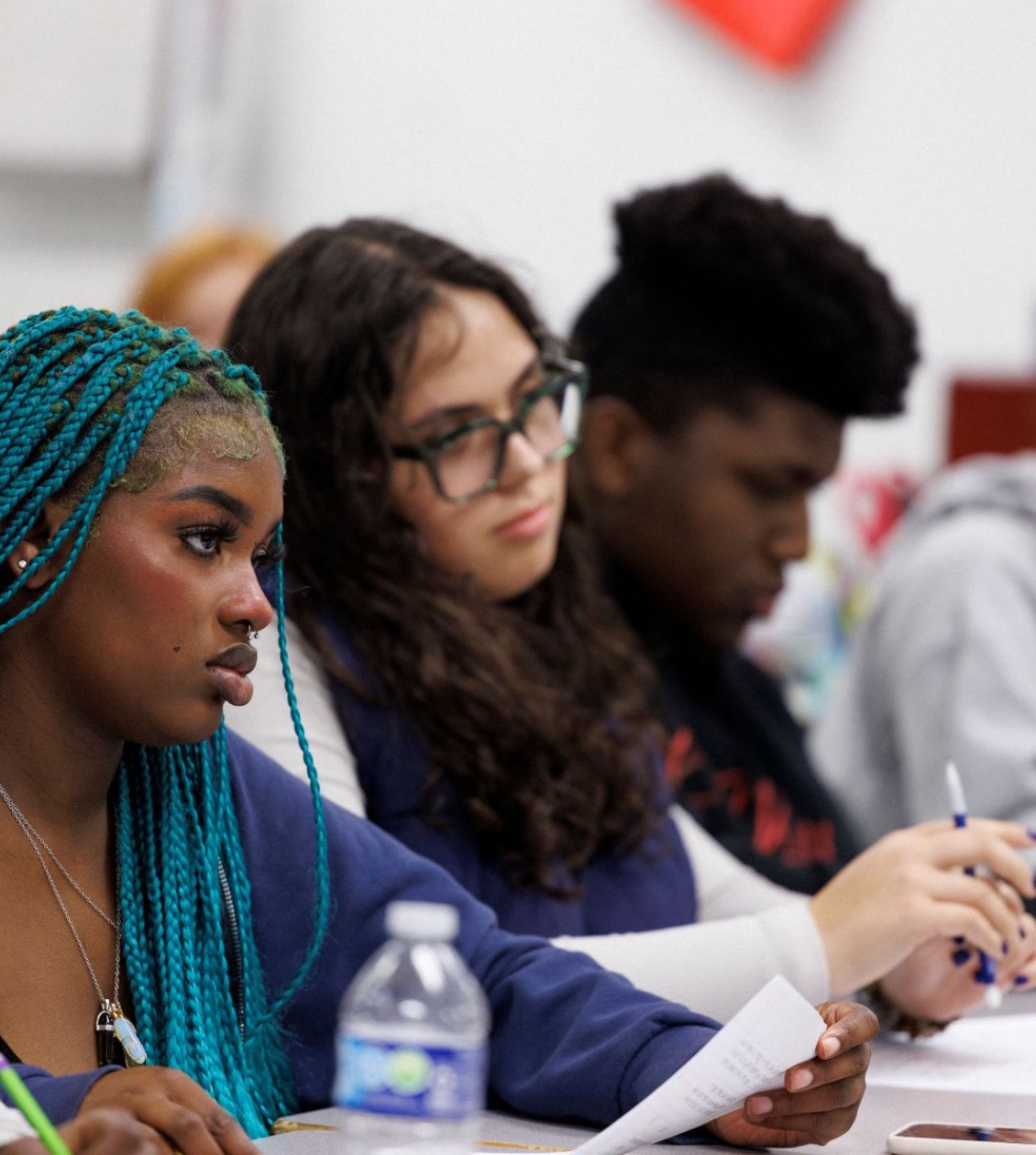 Three high school students in a class