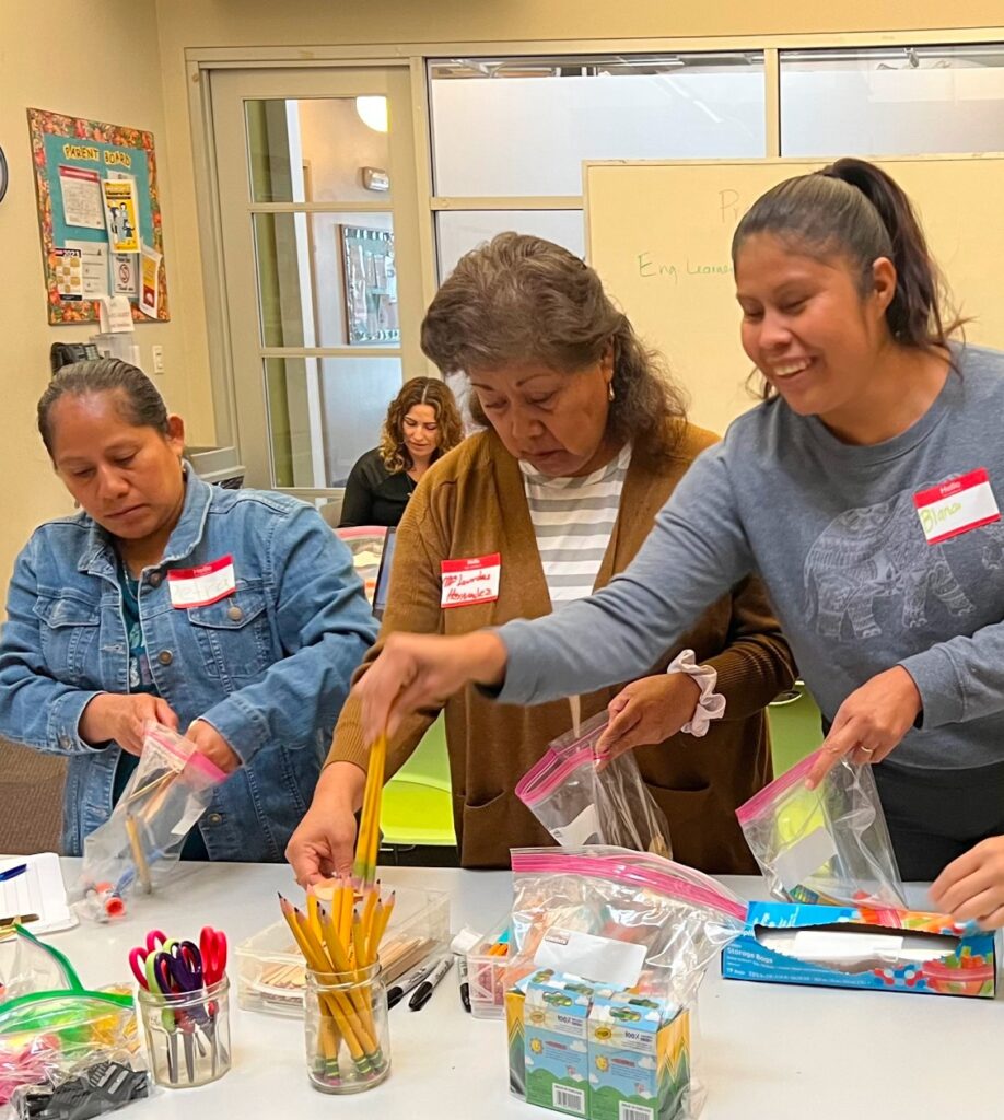 Three women putting things in bags