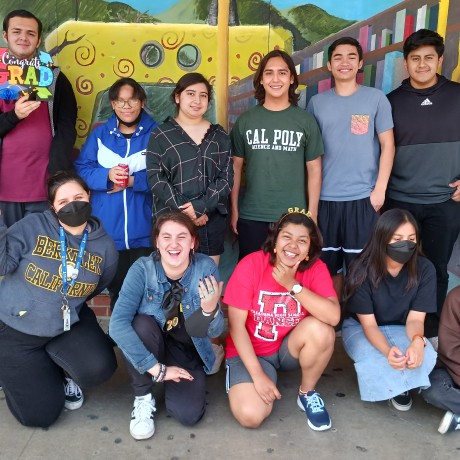 Students taking a photo infront of painted mural