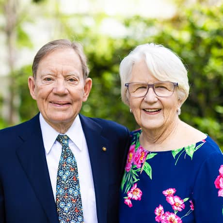 Older man and woman smiling in a photo