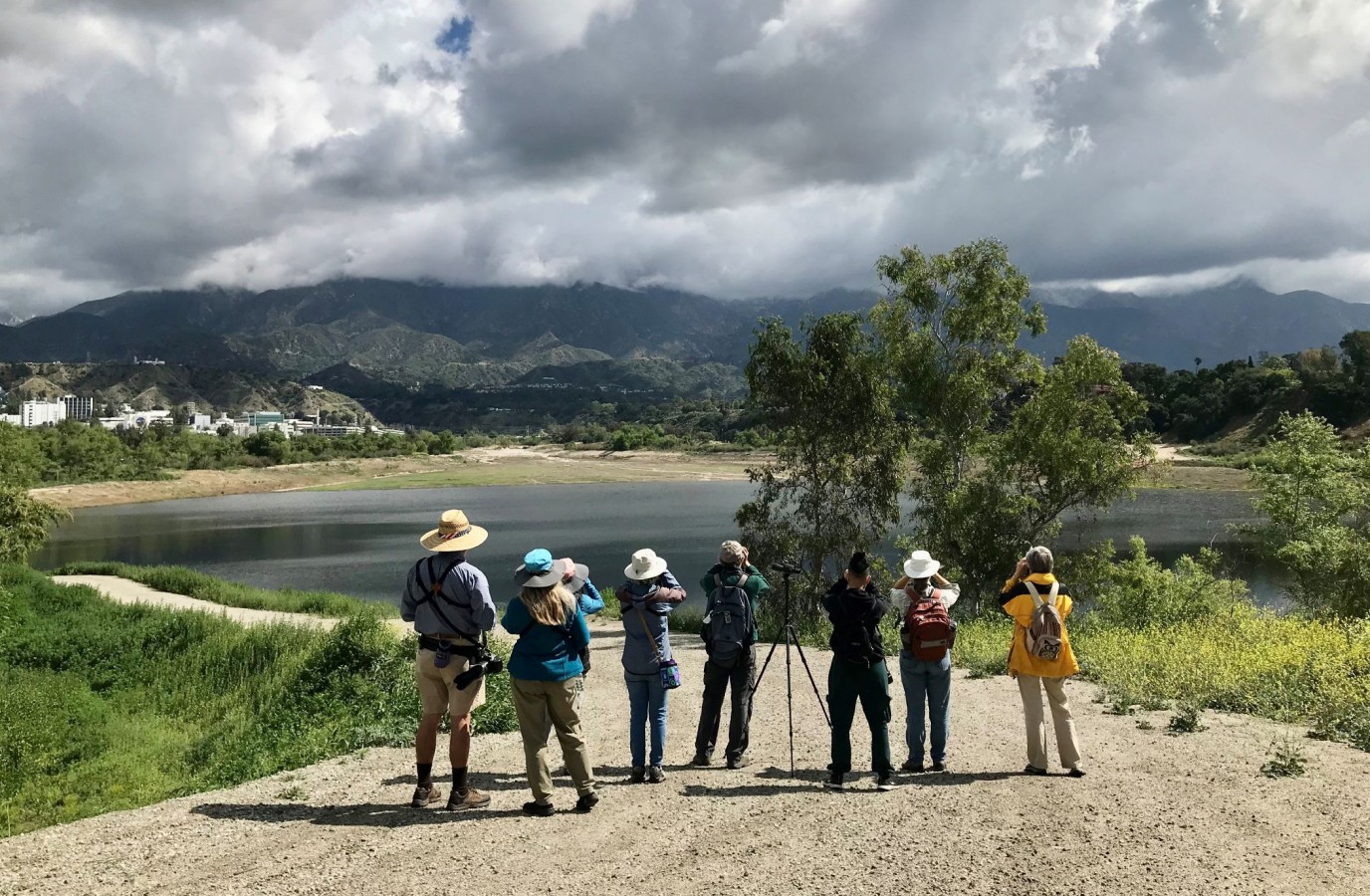 Group of hikers looking off into the distance on a trail