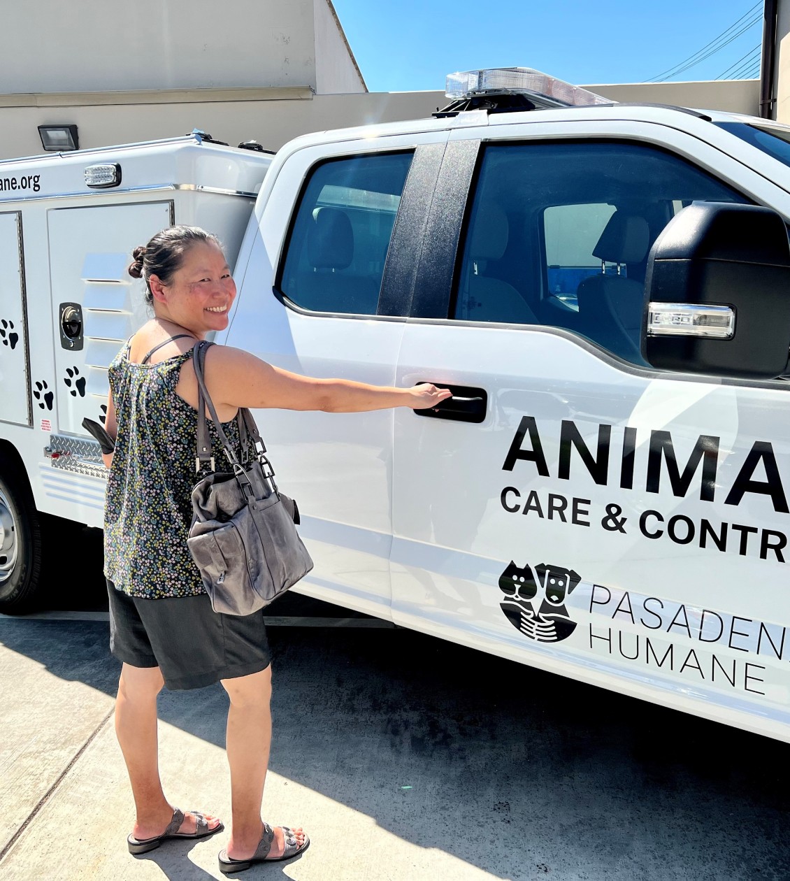 women about to open the passenger side door of an Animal Care Control truck