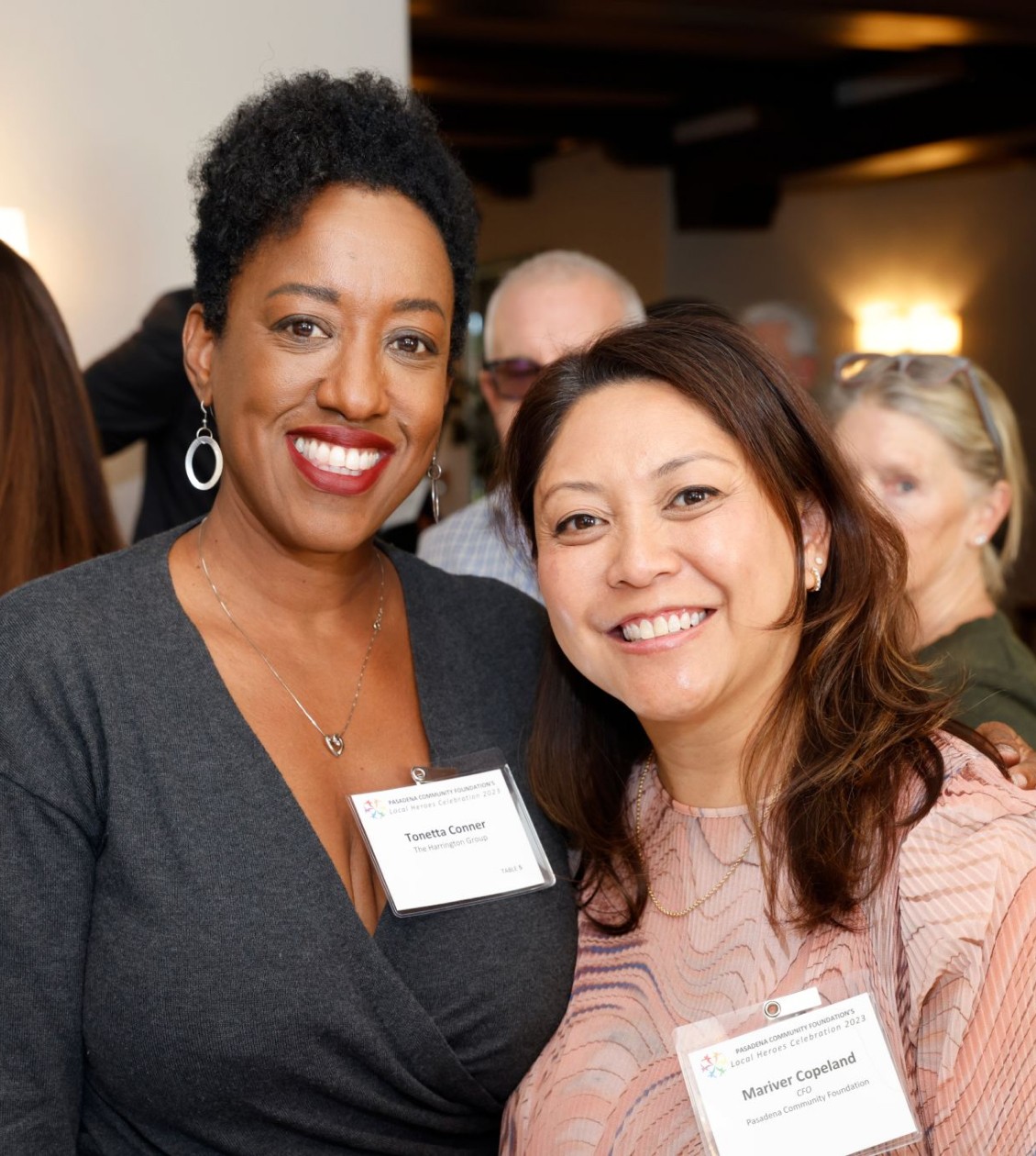 Two women posing for a photo at an event