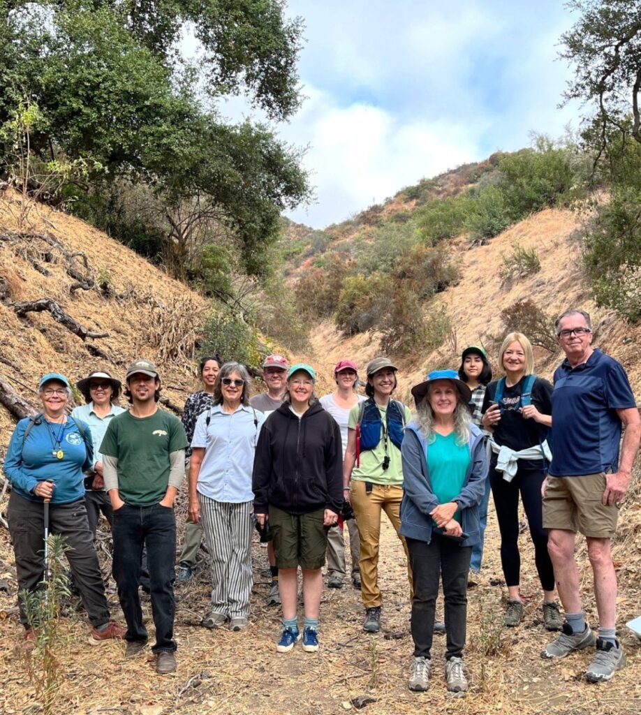 Hiking group posing for a group photo within a valley
