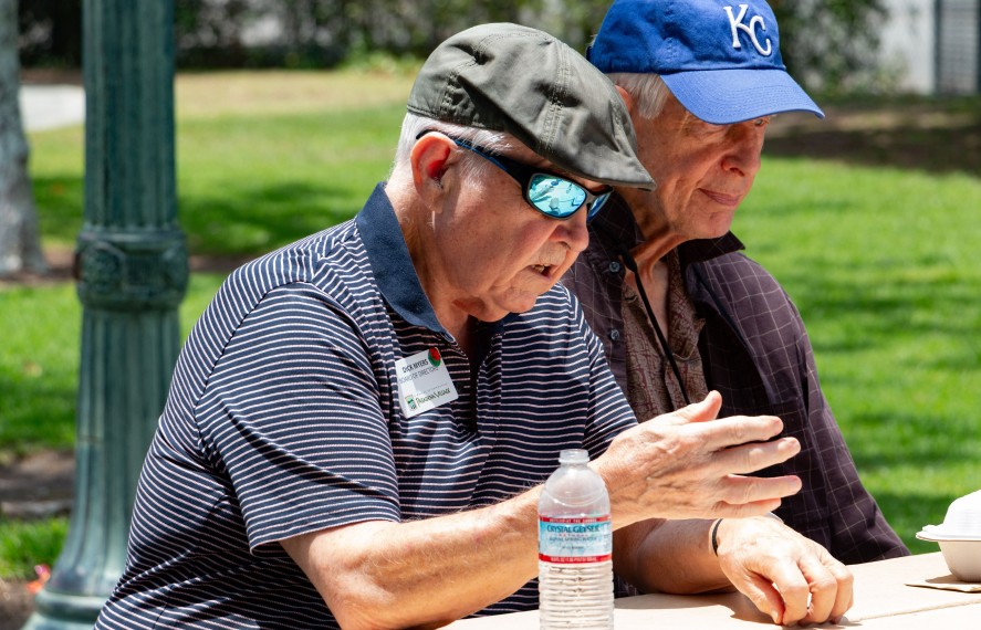 Older men with the Pasadena Village talking and directing outside
