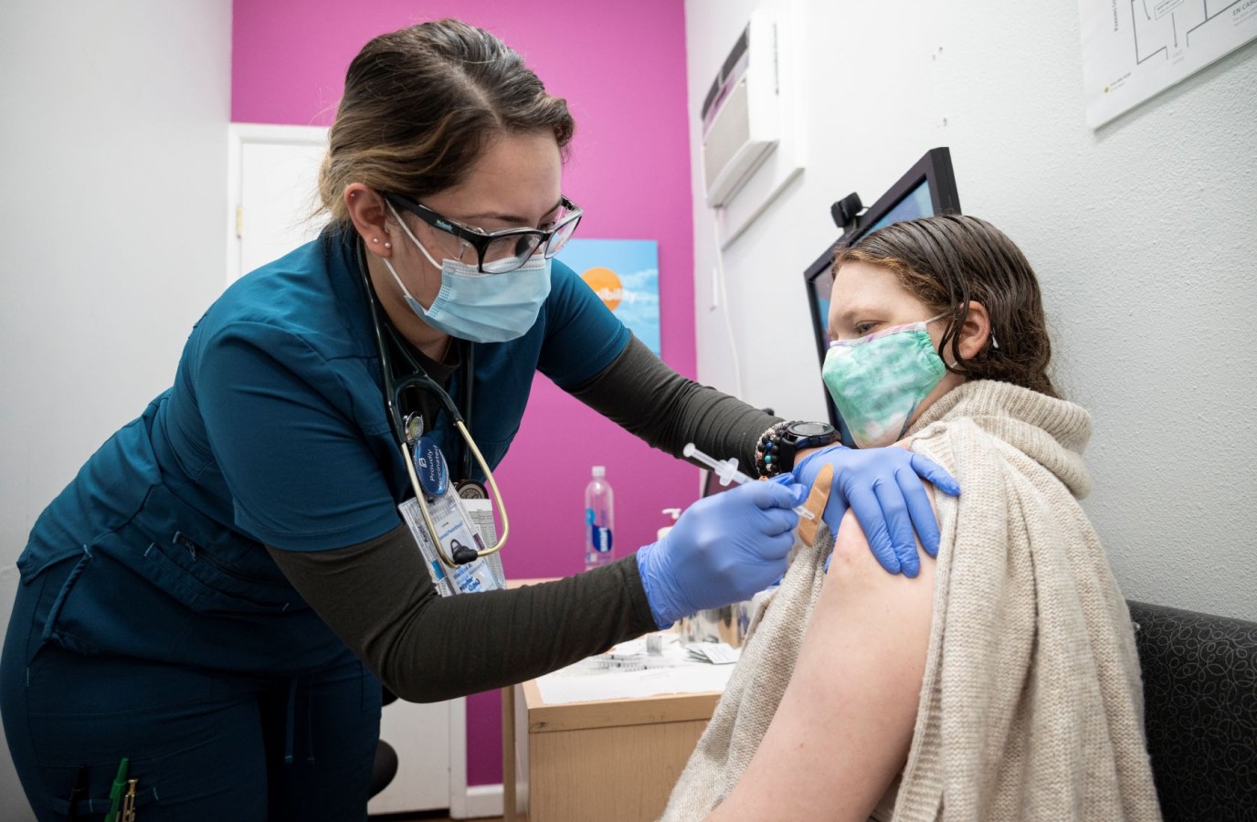 Nurse giving woman a vaccine
