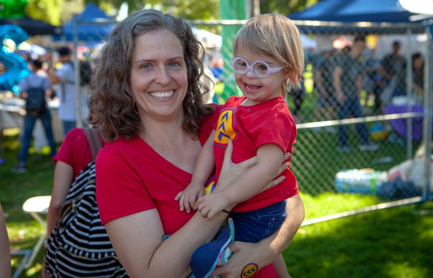Woman holding a child smiling