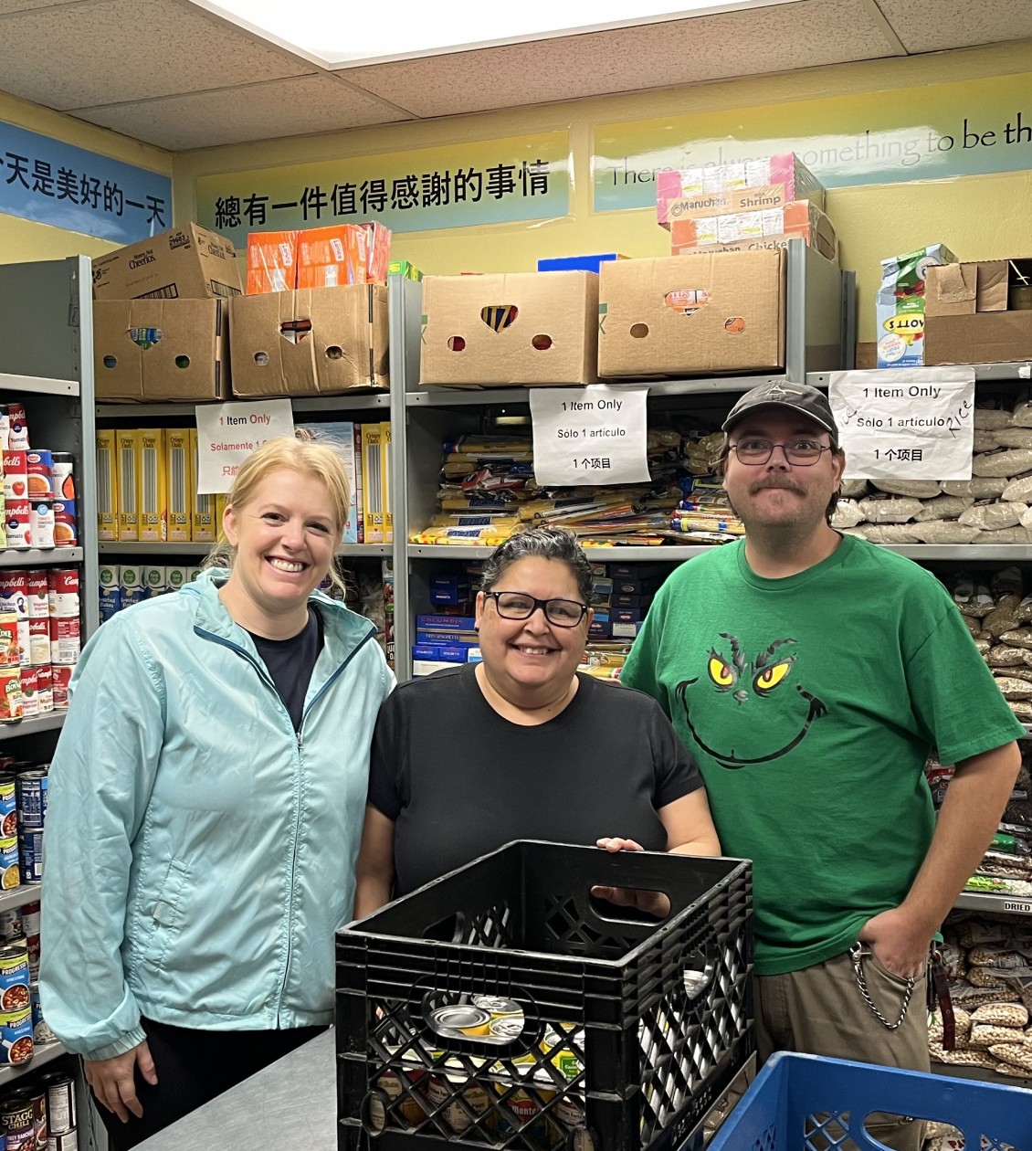 Three people in food bank storage
