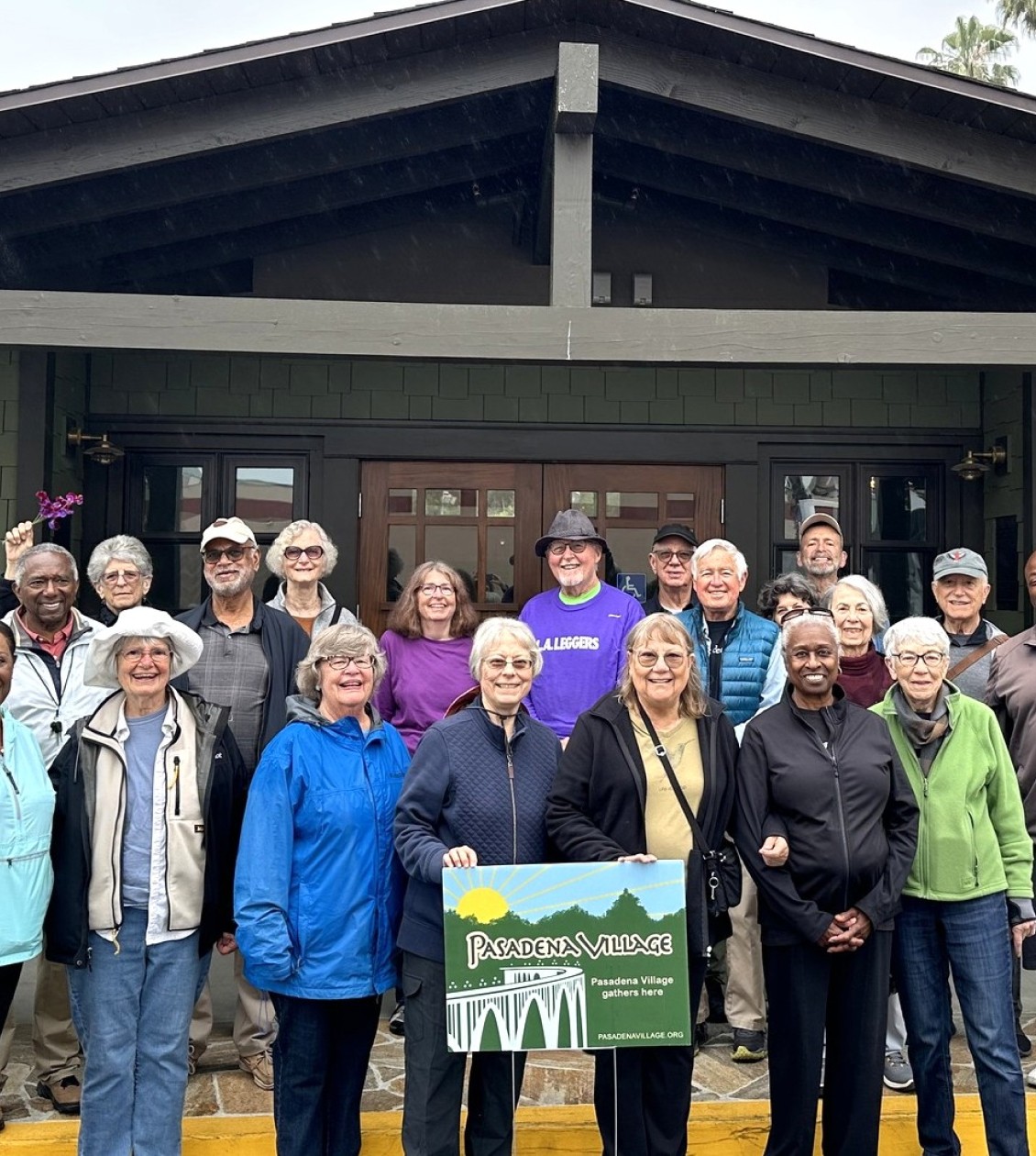 Group of people standing in front of the Pasadena Village