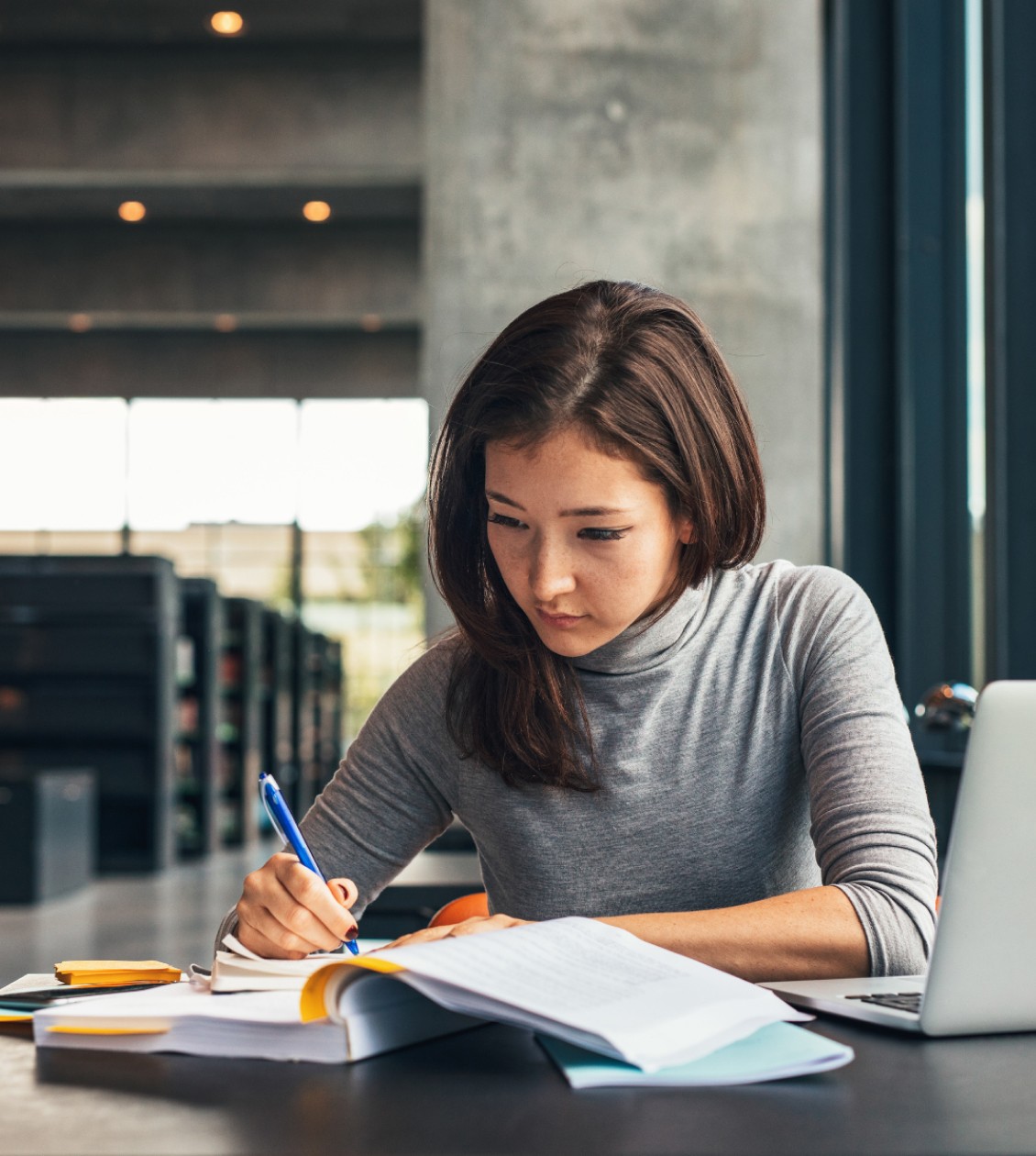 Woman working and writing in a notebook