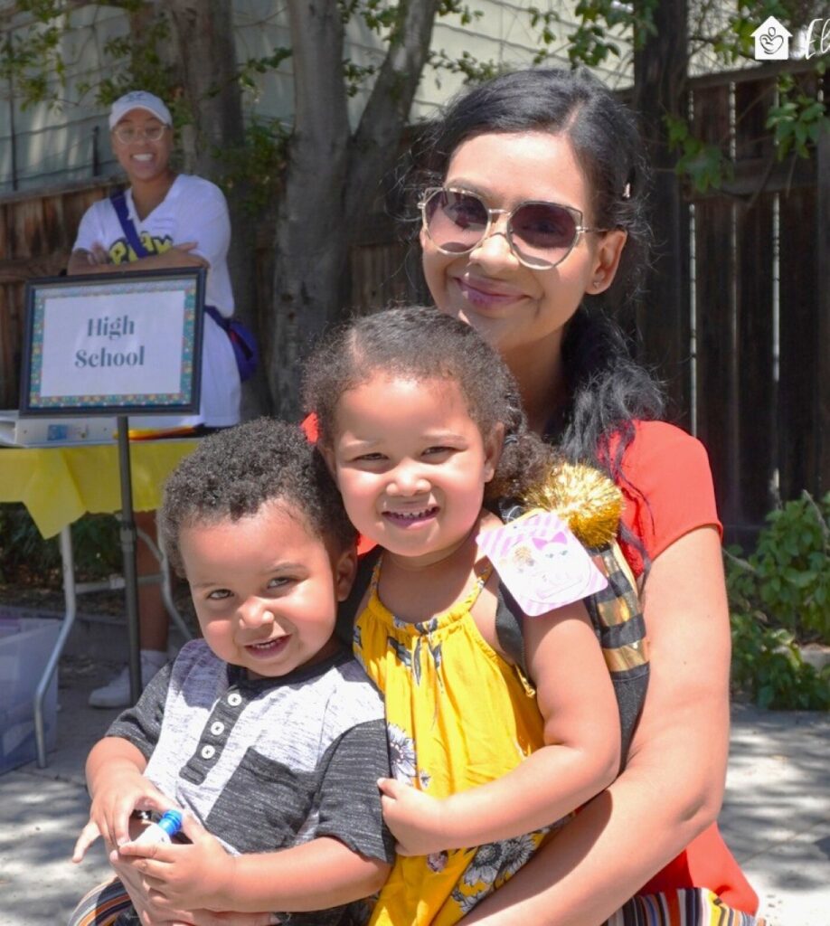 Mother holding her two young children