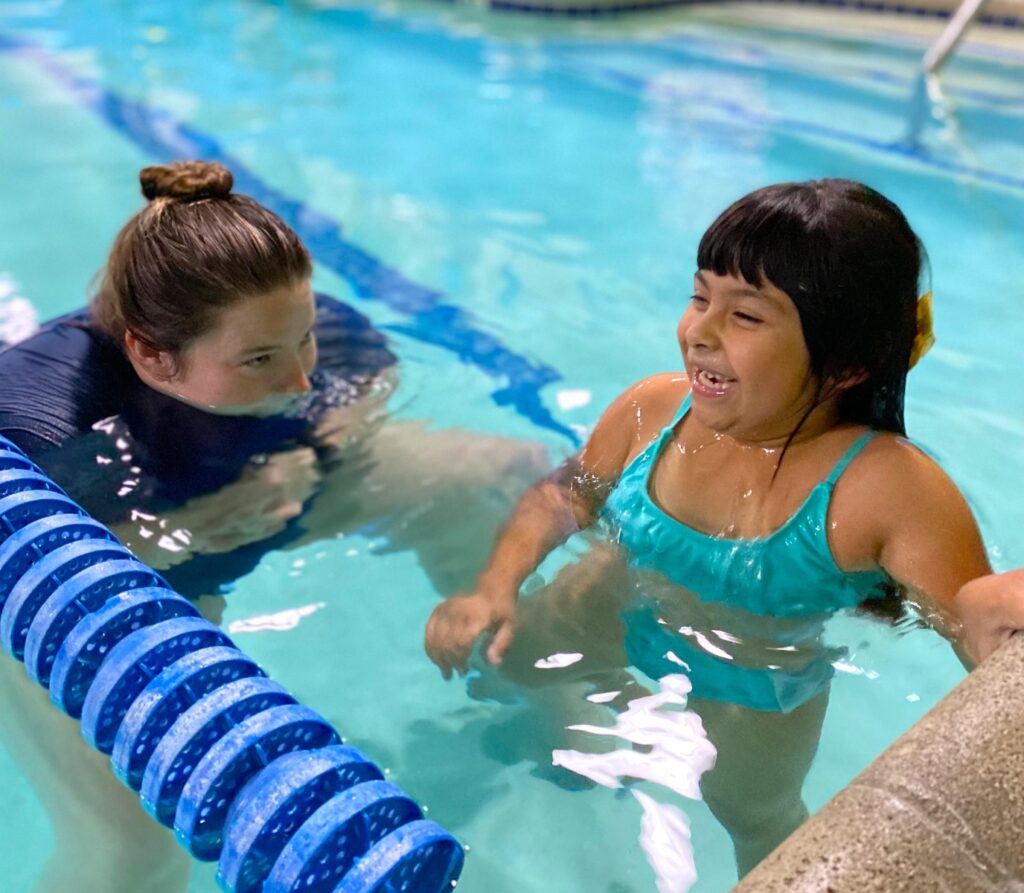 Women with young girl in pool