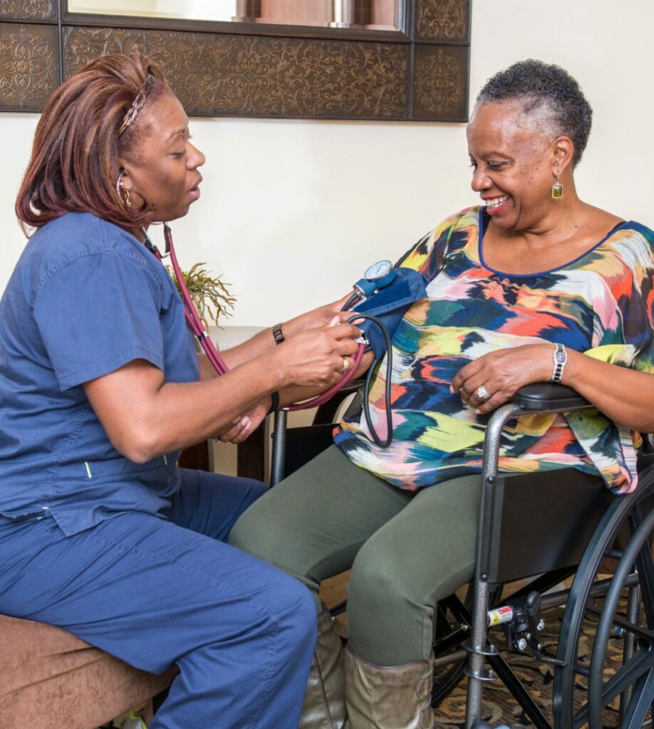 Nurse taking woman's blood pressure