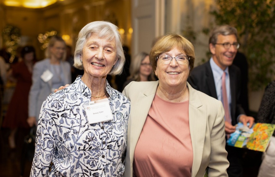 Two women taking a photo together at a PCF event