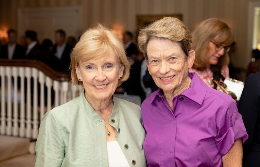 Two women taking a photo together at a PCF event