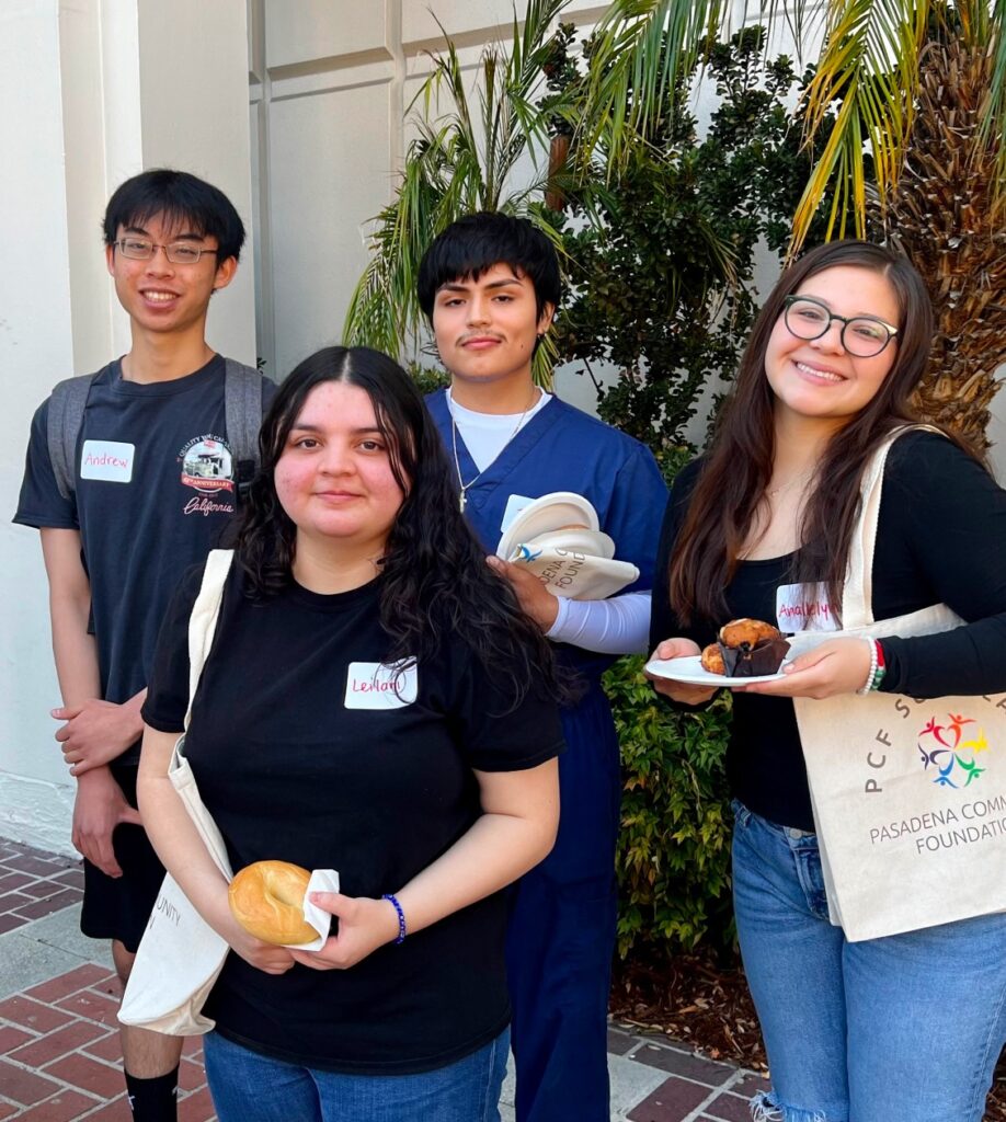 Group of students with food in their hand posing for a photo