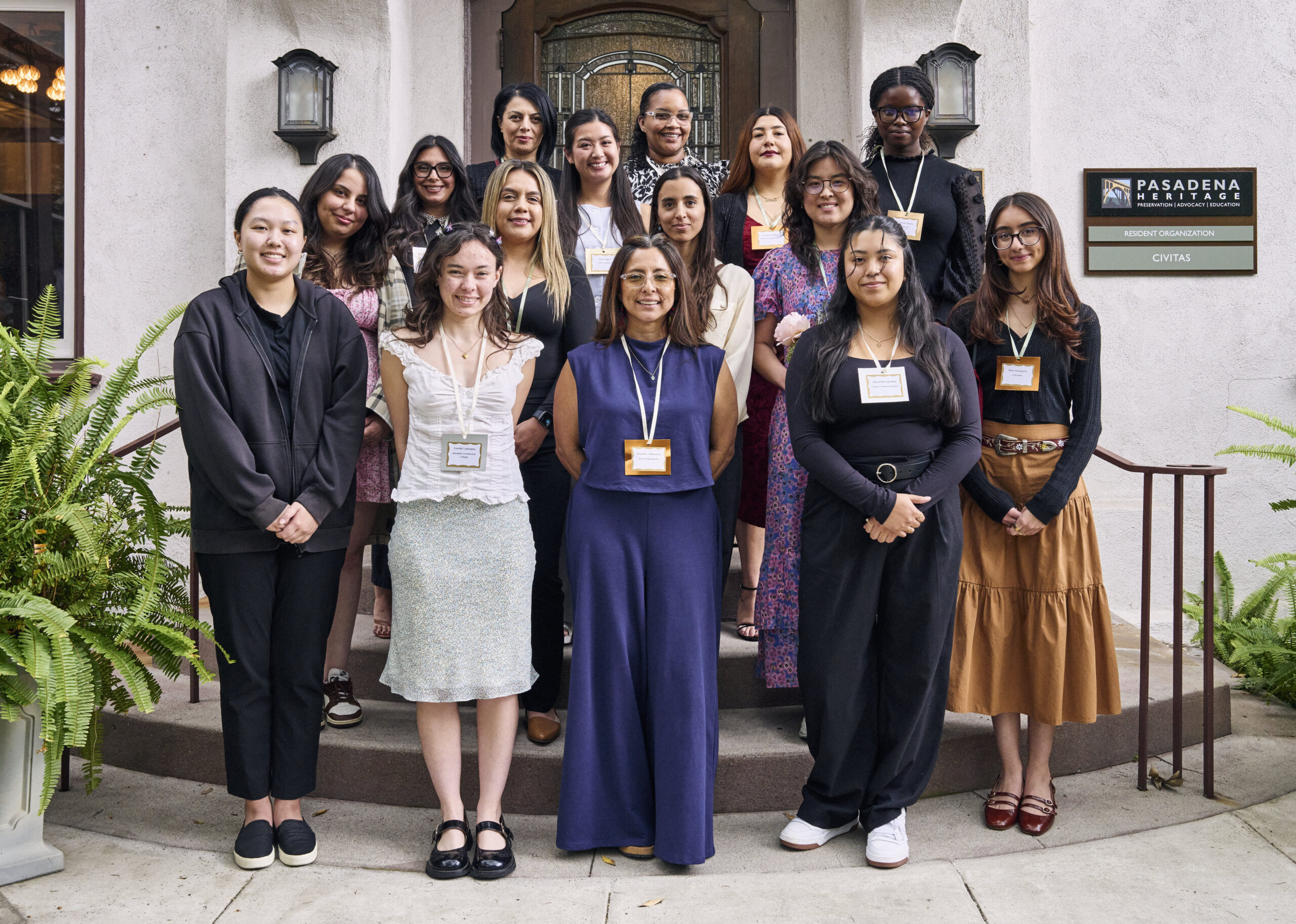 Young women pose for a group photo outdoors.