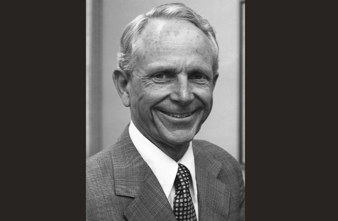 A vintage black and white headshot of an older white man