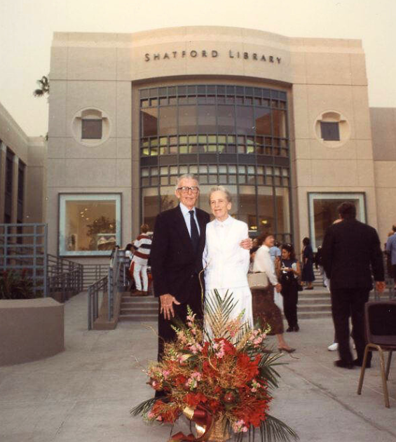 An older couple stand together outside the Shatford Library at PCC in Pasadena CA