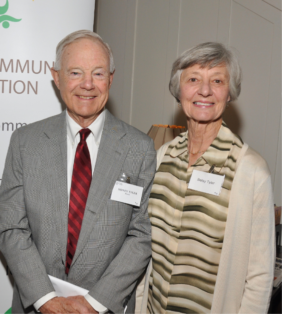 An older white couple stand together