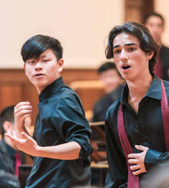 Two teens boys are gesturing and singing