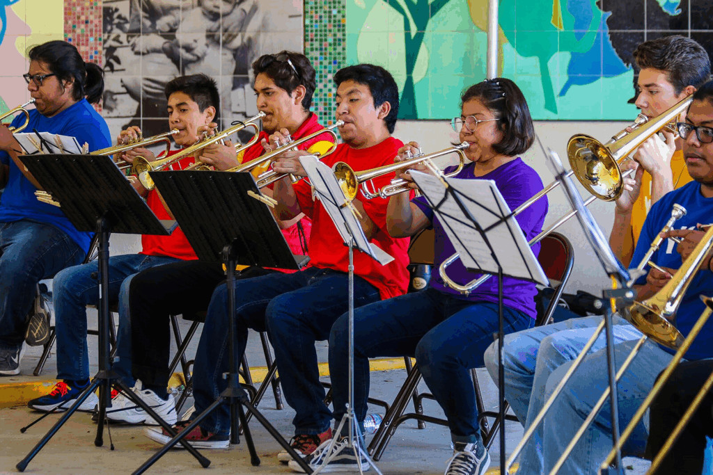 A diverse youth band plays brass instruments.